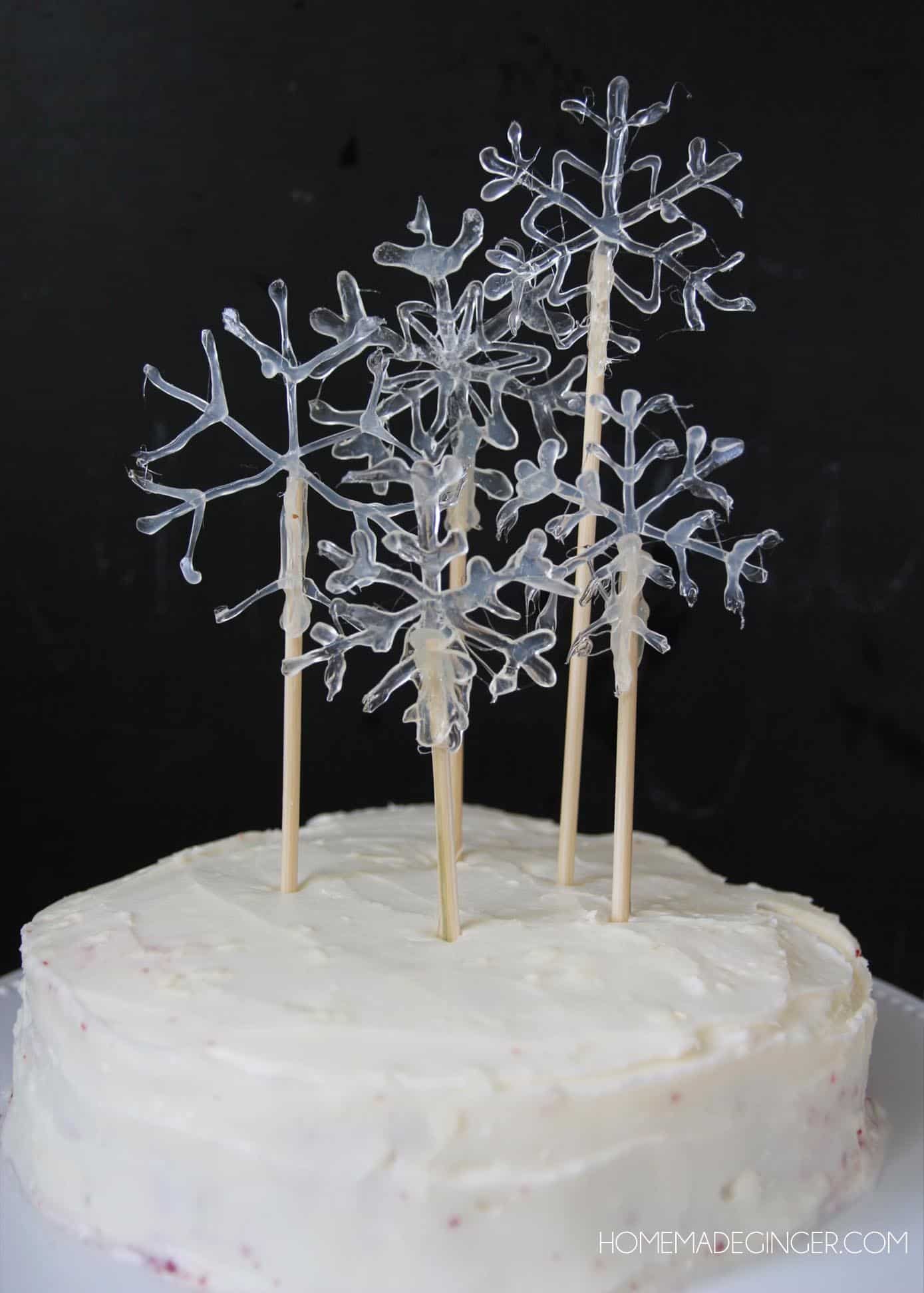 Easy snowflake cake toppers using hot glue and skewers