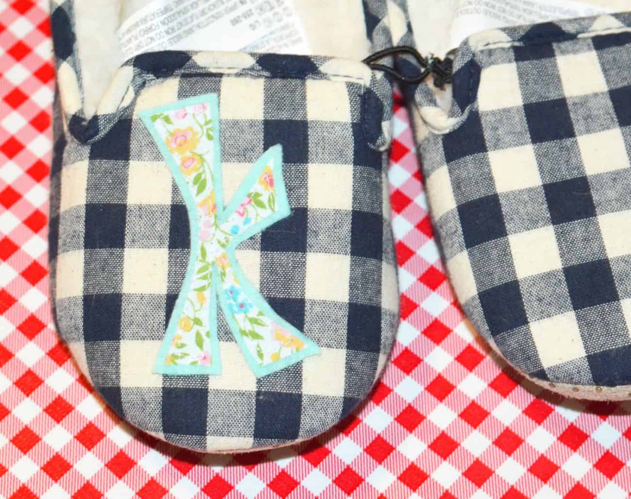 Slipper with a "K" applique glued to the toe