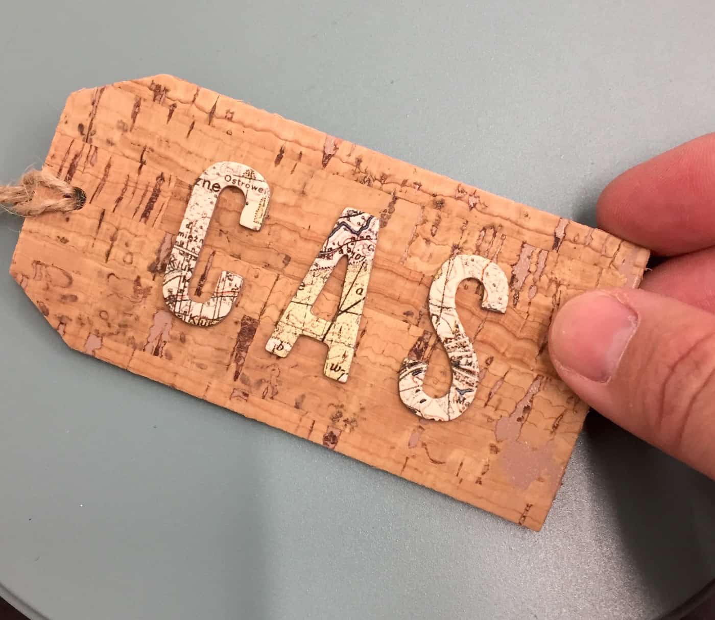Cork gift tag with the initials "CAS" on top