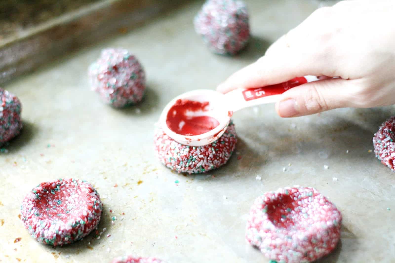 Making the thumbprint in some red velvet cookies