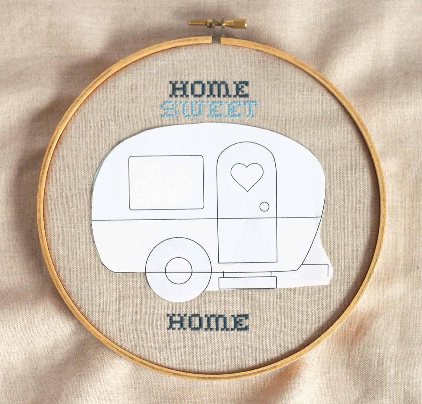 Embroidery hoop with linen and a paper pattern on top