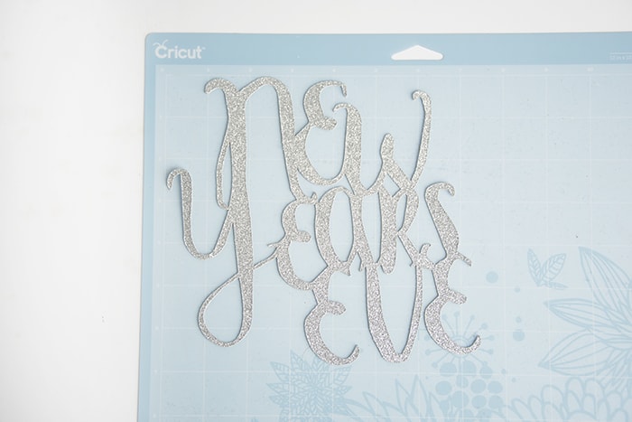 New Year's Eve glitter cutout stuck to a Cricut mat