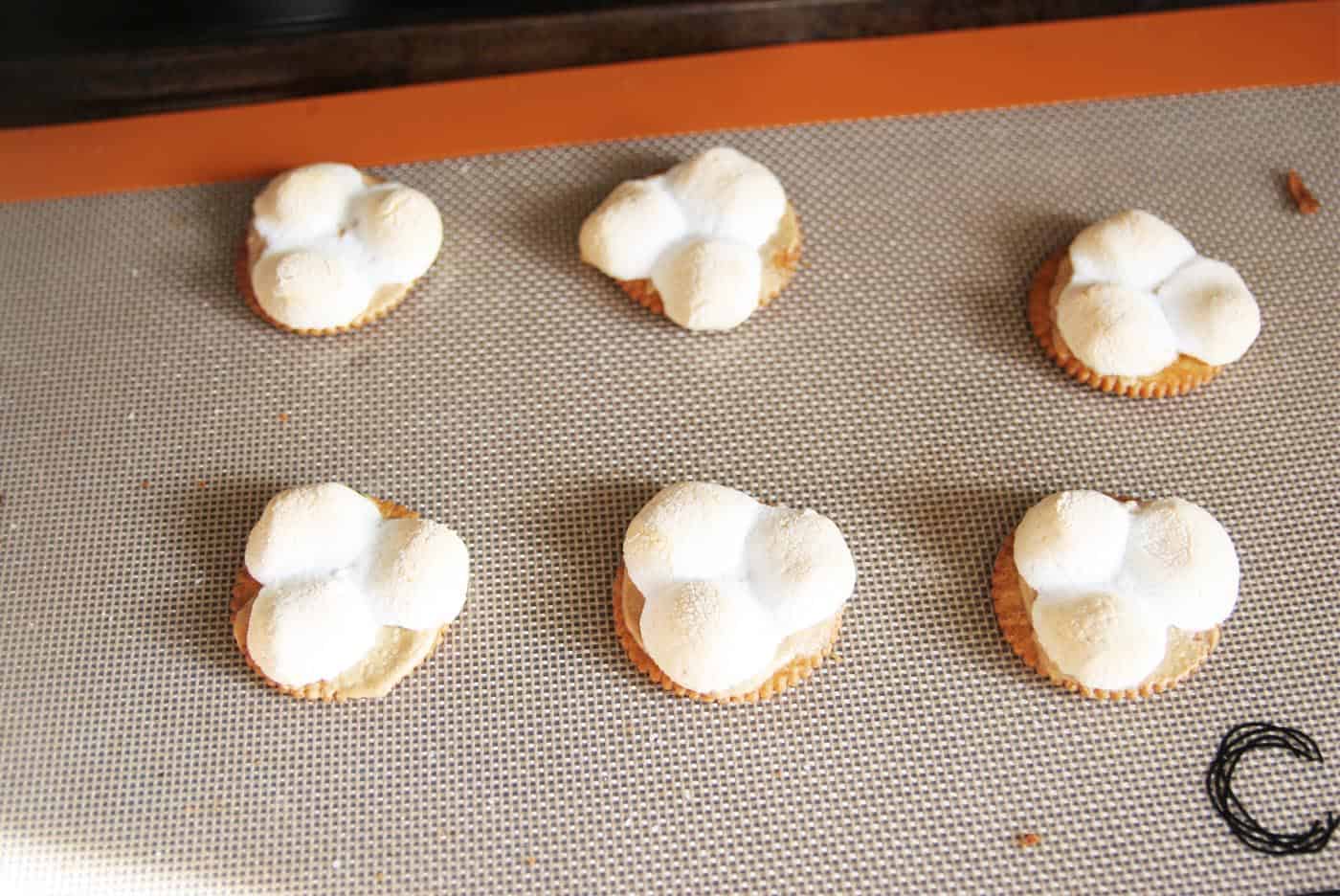 Marshmallows on top of crackers in the oven