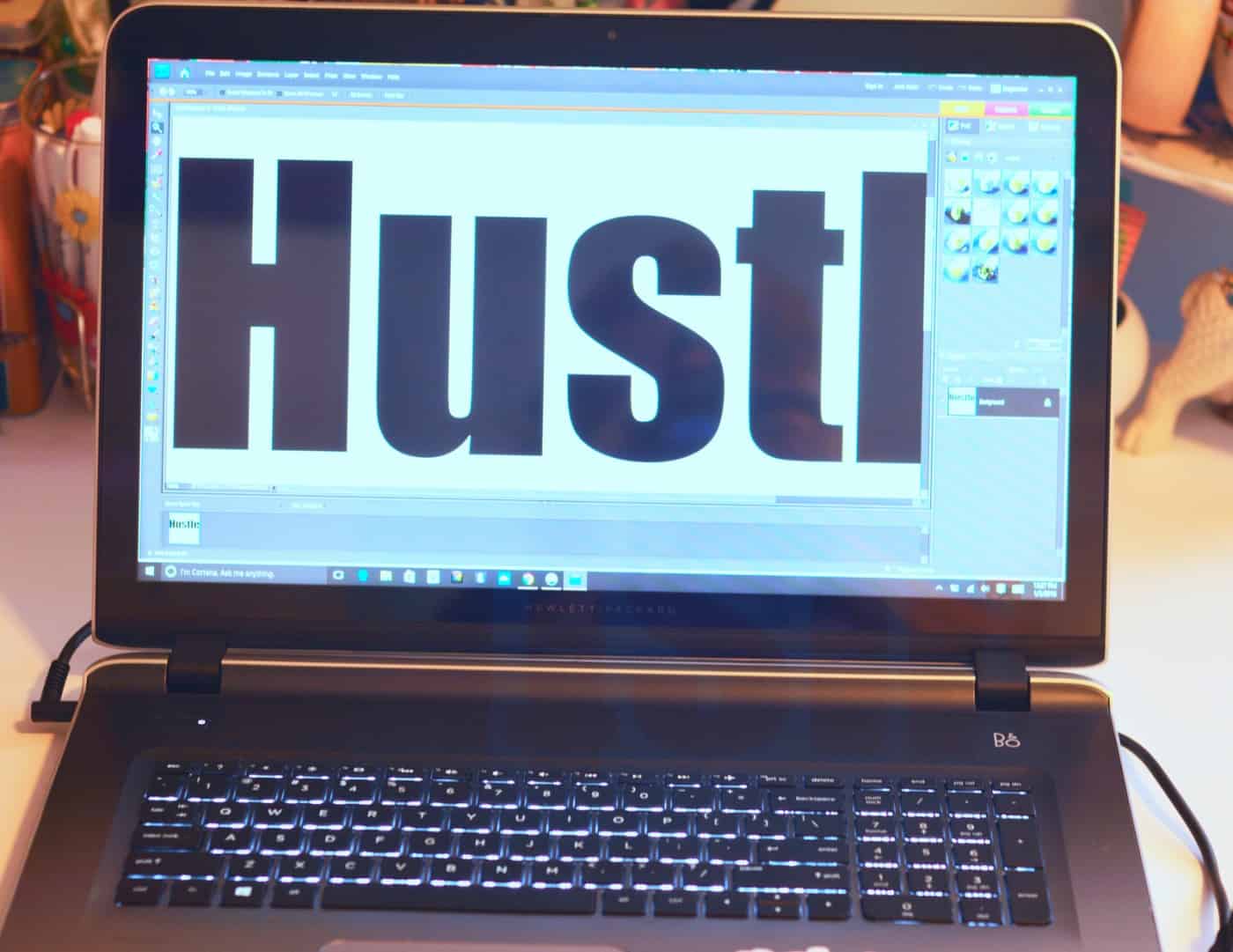 The word hustle on the screen of a laptop computer