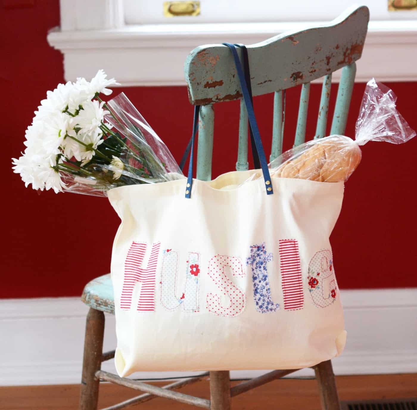 DIY applique tote hanging off the back of a chair