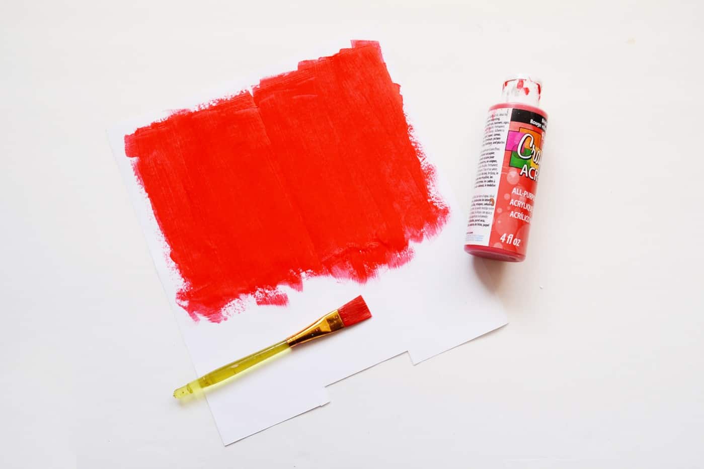 Red acrylic paint on a piece of adhesive paper