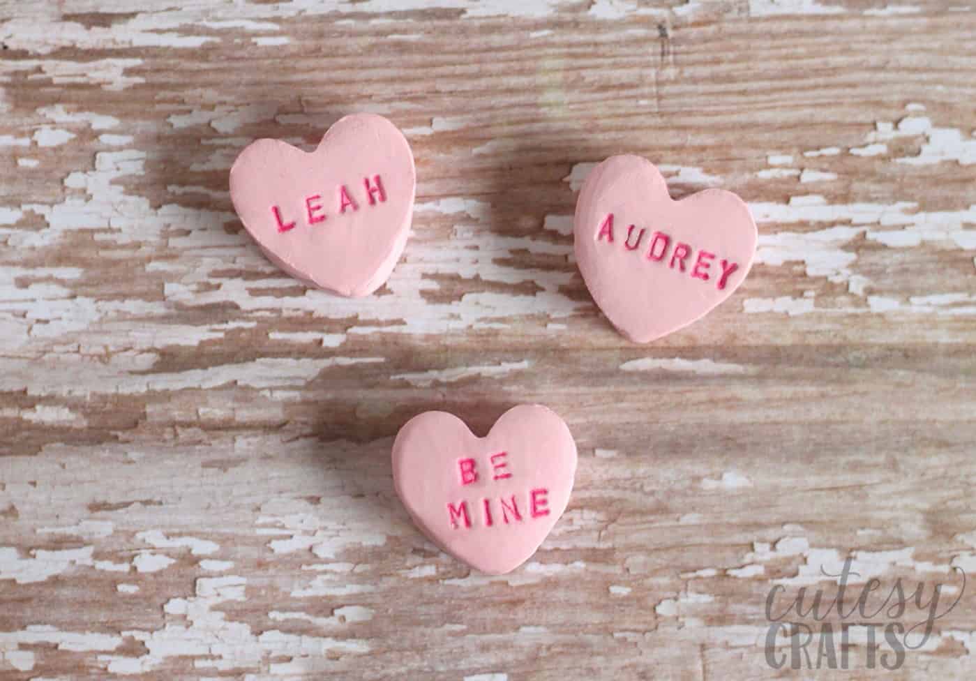 Finished clay hearts that say "Leah," "Audrey," and "Be Mine"