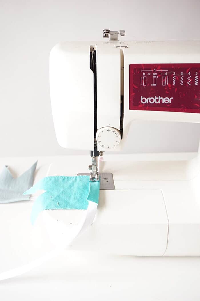Sewing denim scraps onto fabric twill using a sewing machine