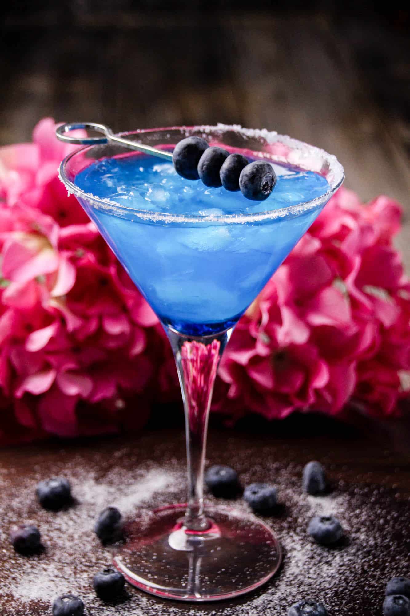 Make this delicious blueberry margarita cocktail in minutes! You'll taste the margarita flavor with a pretty blue color. Use fresh blueberries to adorn the glass and salted sugar on the rim!