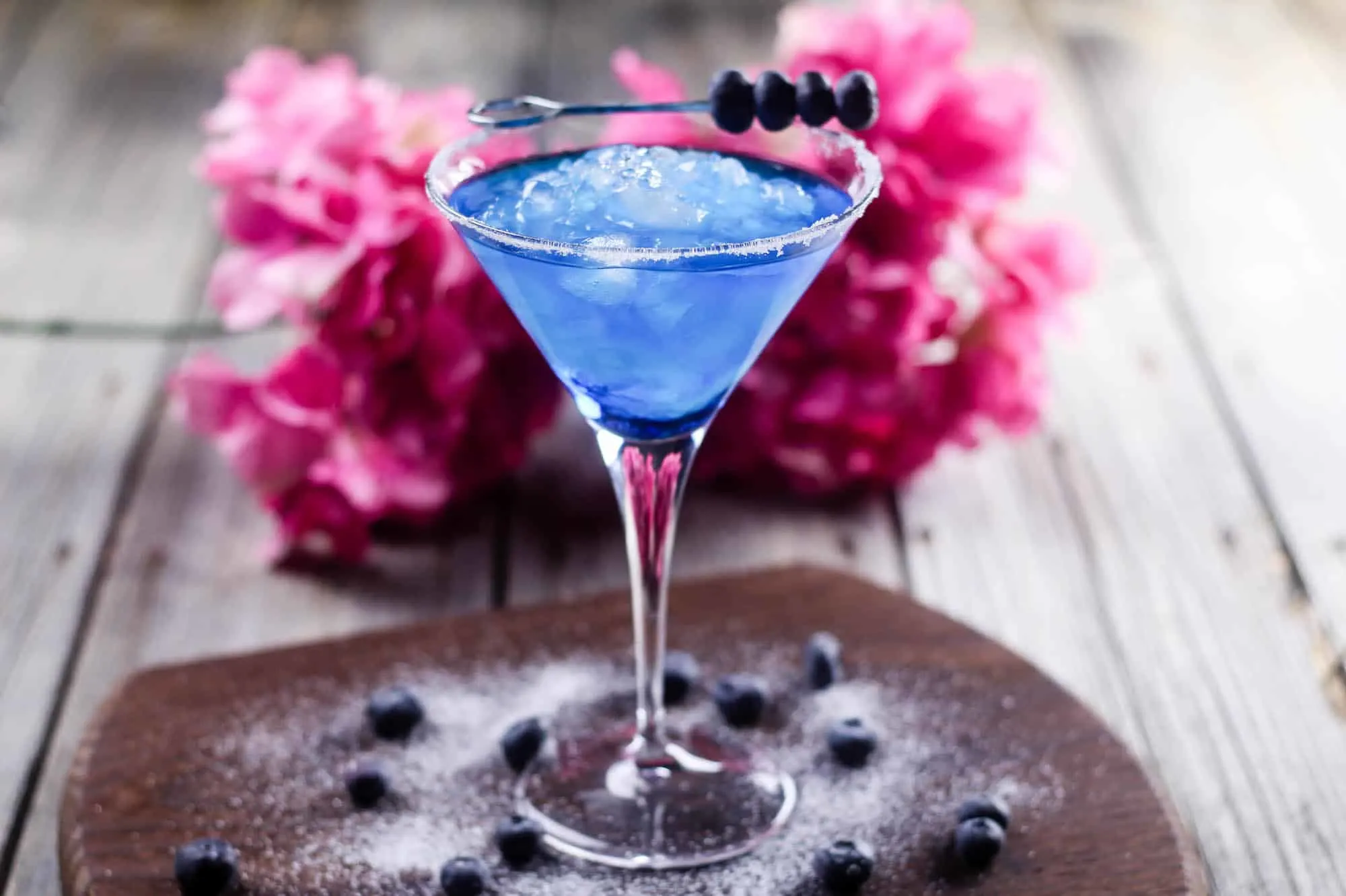 Make this delicious blueberry margarita cocktail in minutes! You'll taste the margarita flavor with a pretty blue color. Use fresh blueberries to adorn the glass and salted sugar on the rim!