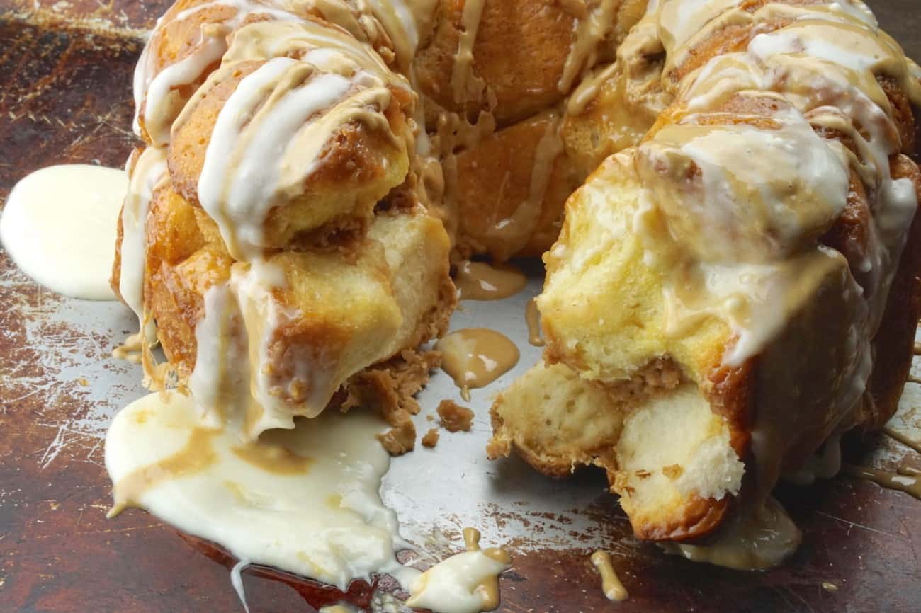 Peanut butter monkey bread recipe with a piece taken out on a baking pan