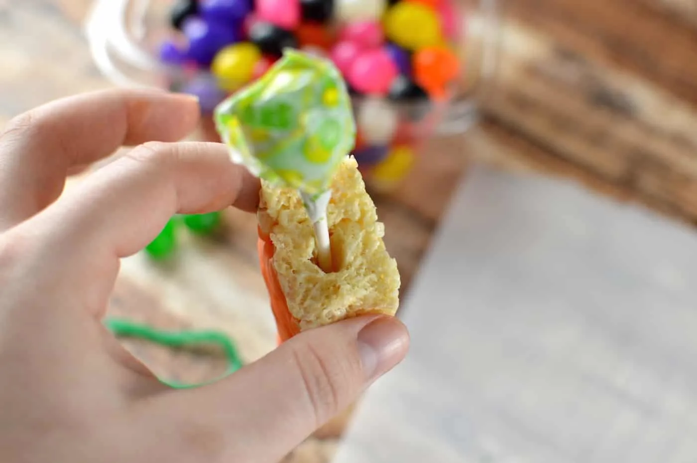 Sticking a lollipop into the top of a rice krispie treat