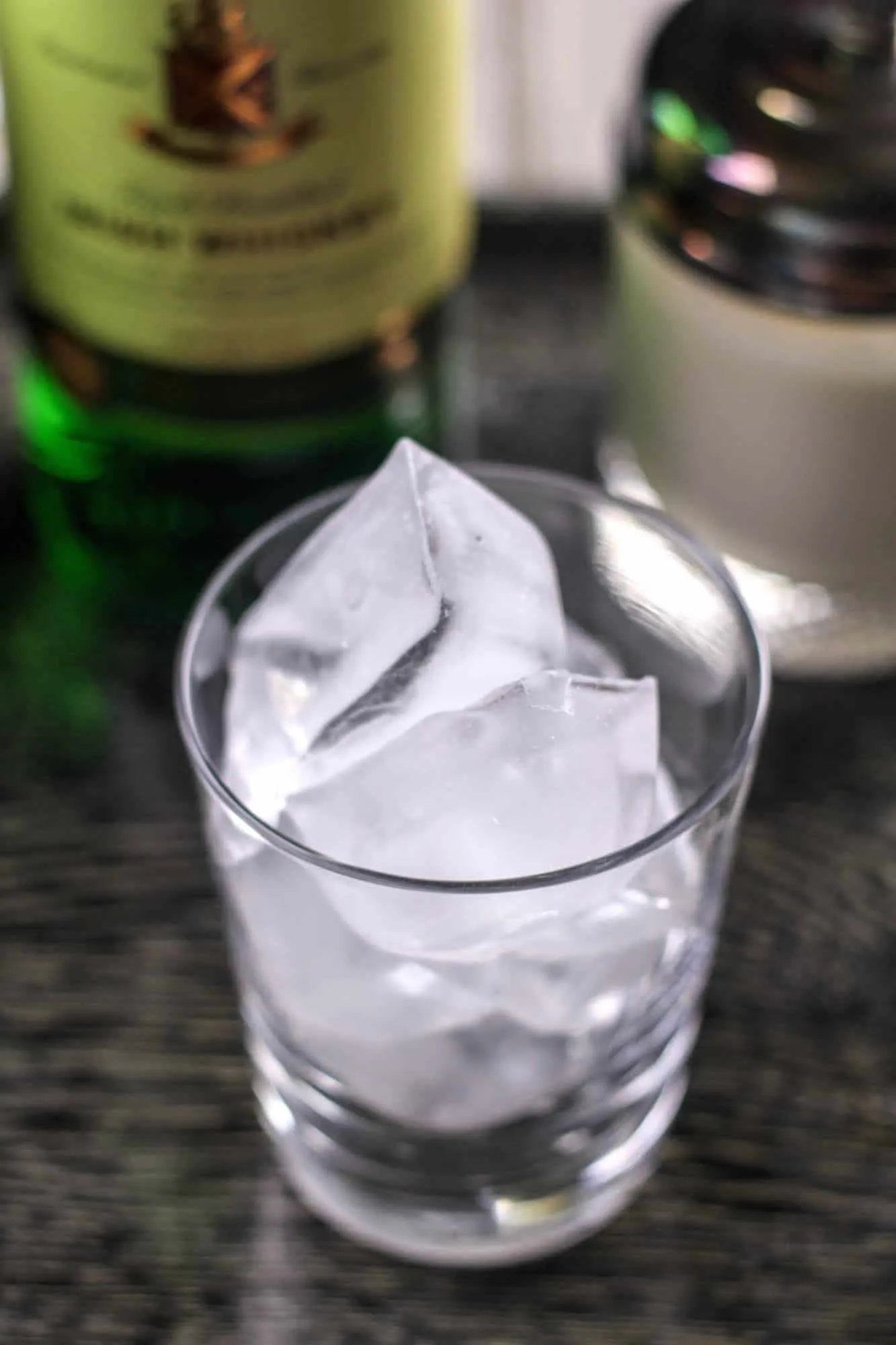 Empty whiskey glass with ice cubes