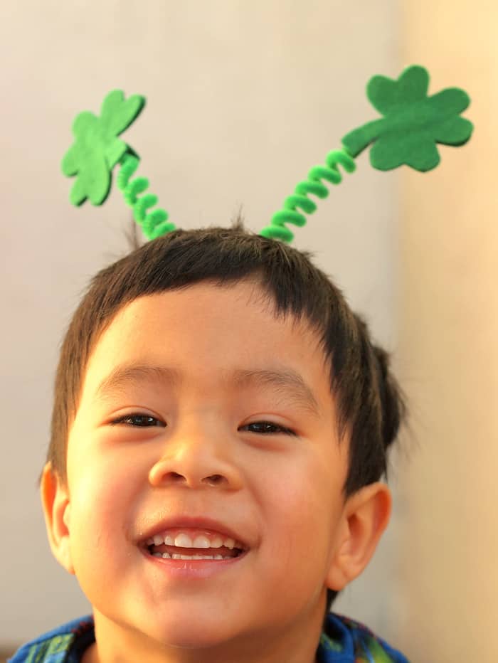 Male child wearing a shamrock headband for St. Patrick's Day