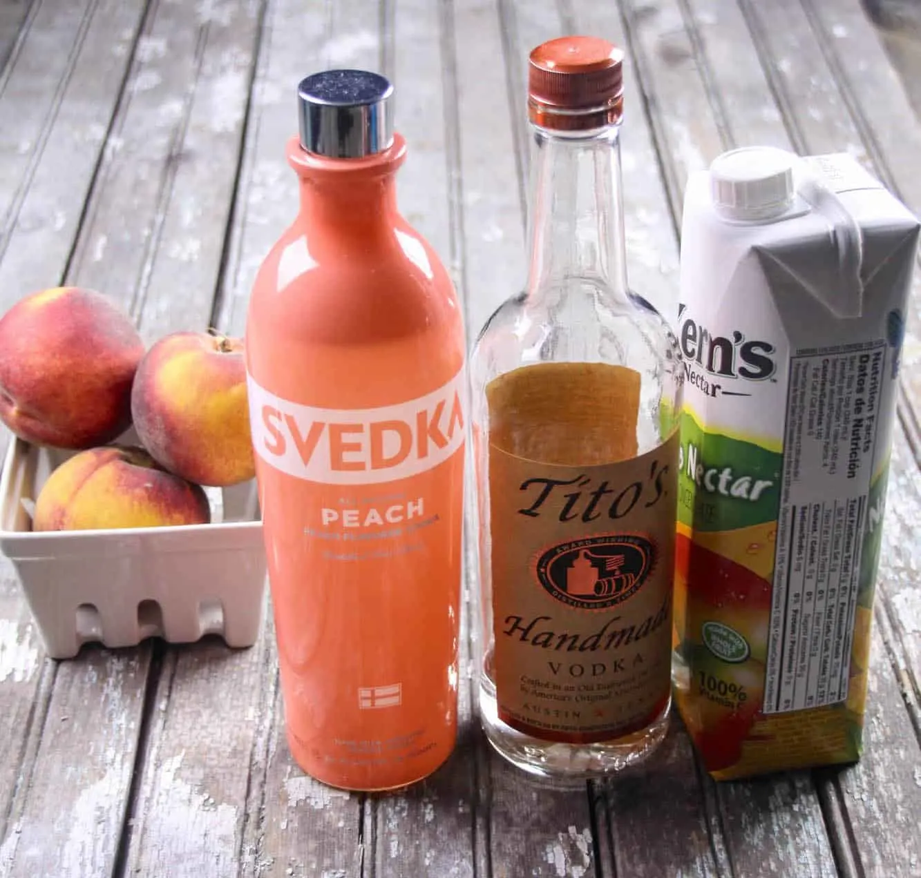 Svedka peach vodka, Tito's handmade vodka, peaches, and Kern's peach nectar