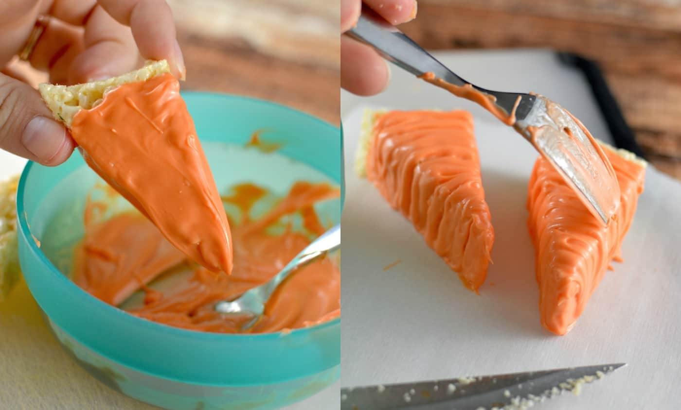 Dipping rice krispy treats into orange candy melts