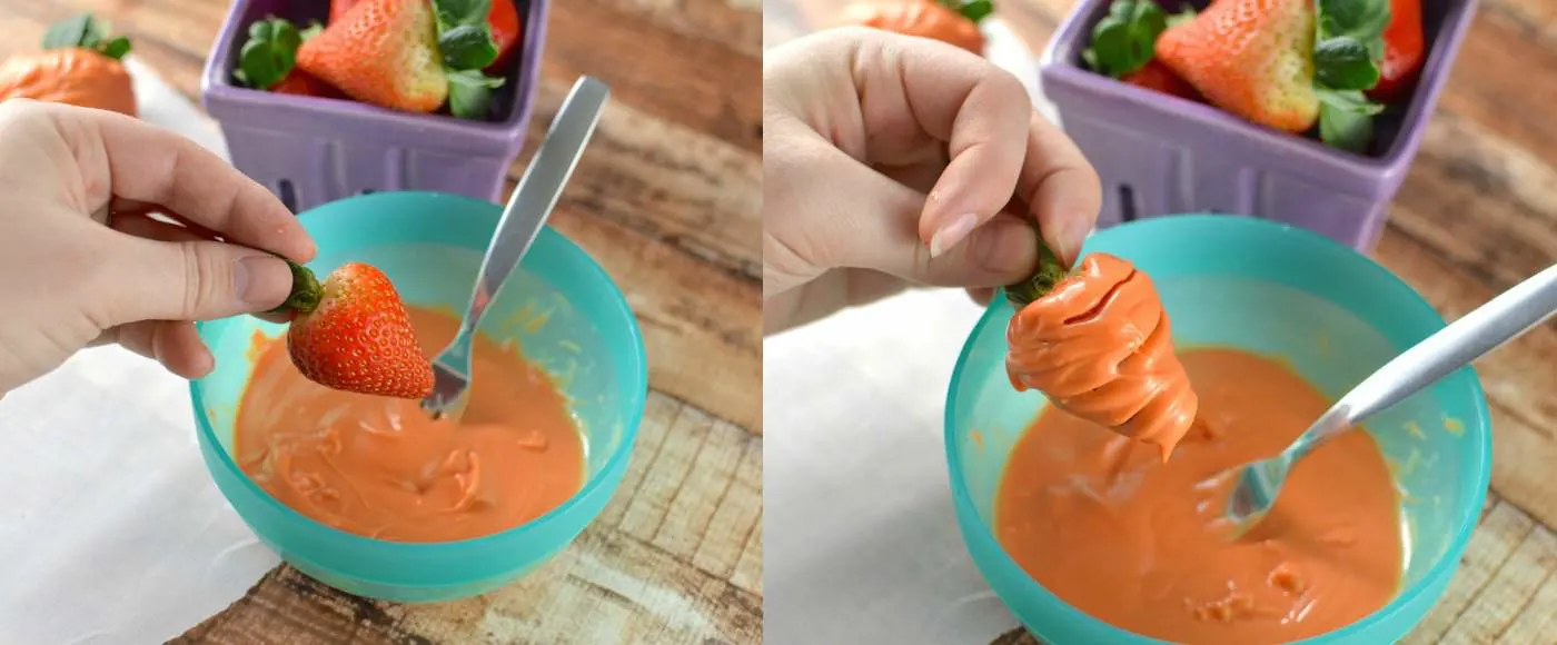 dip strawberries into the orange candy melts