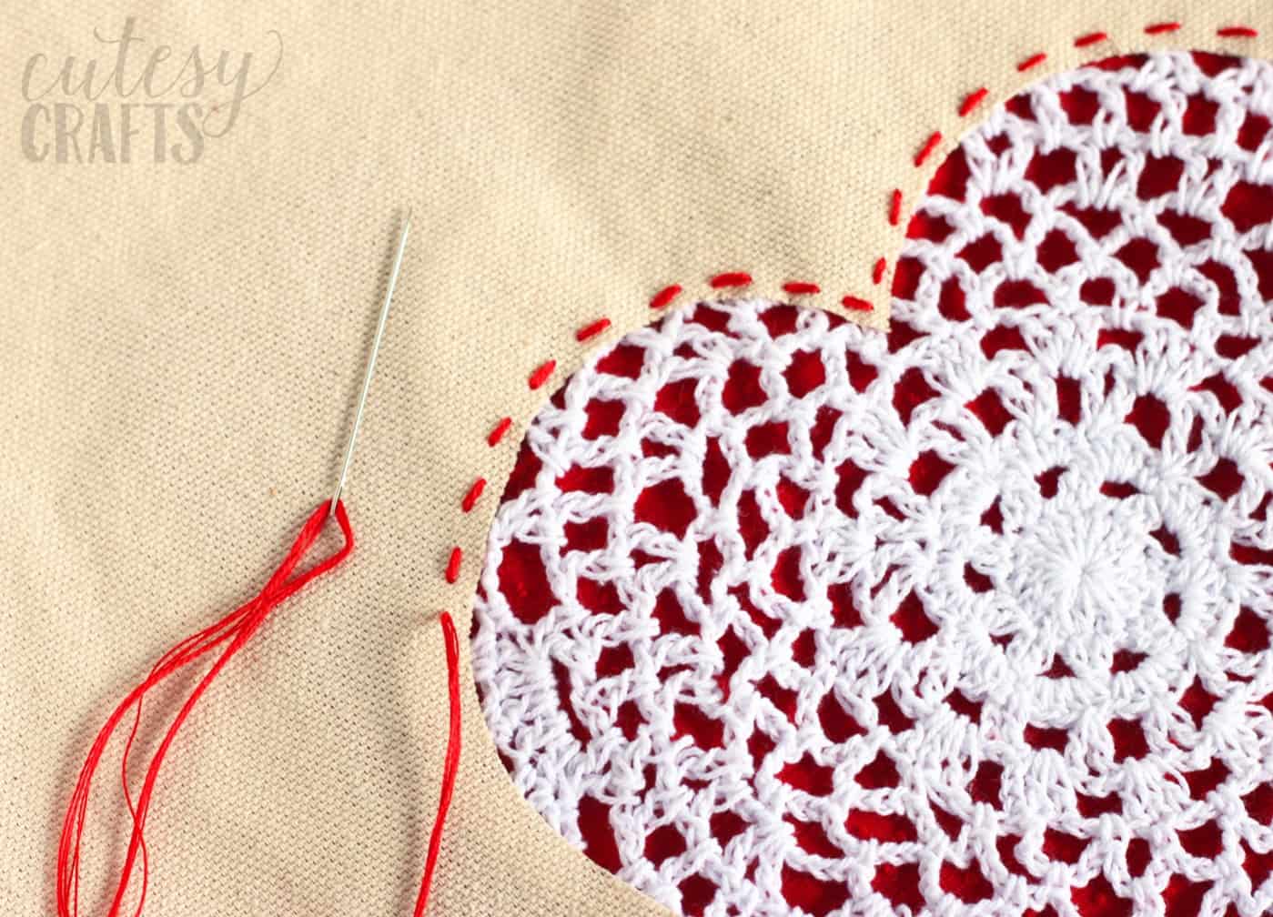 Running stitch sewn in red embroidery thread about the edge of the heart