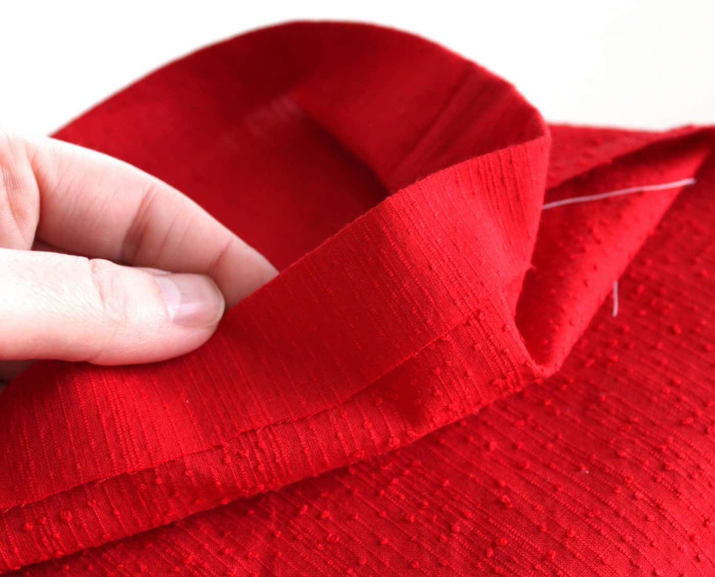 One inch edge of the red fabric folded over and ironed