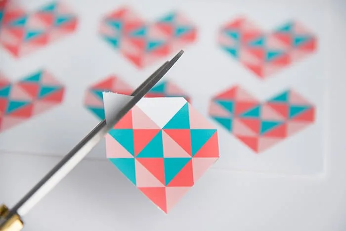 Cutting the heart shapes out of the paper using scissors