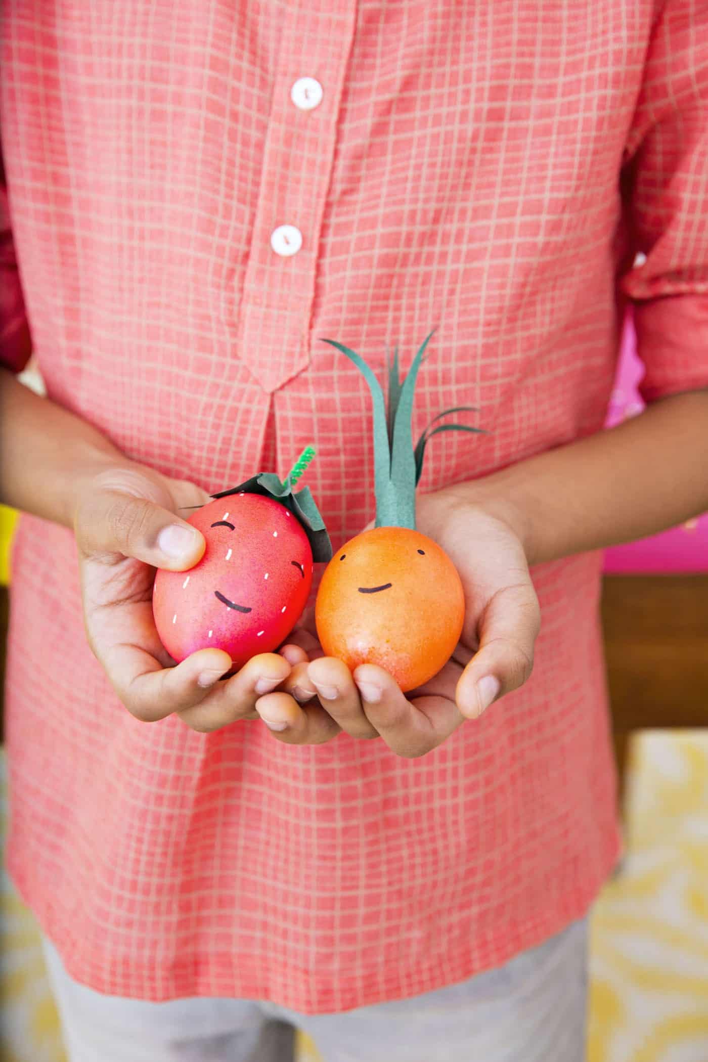 Easter eggs decorated like a strawberry and a carrot