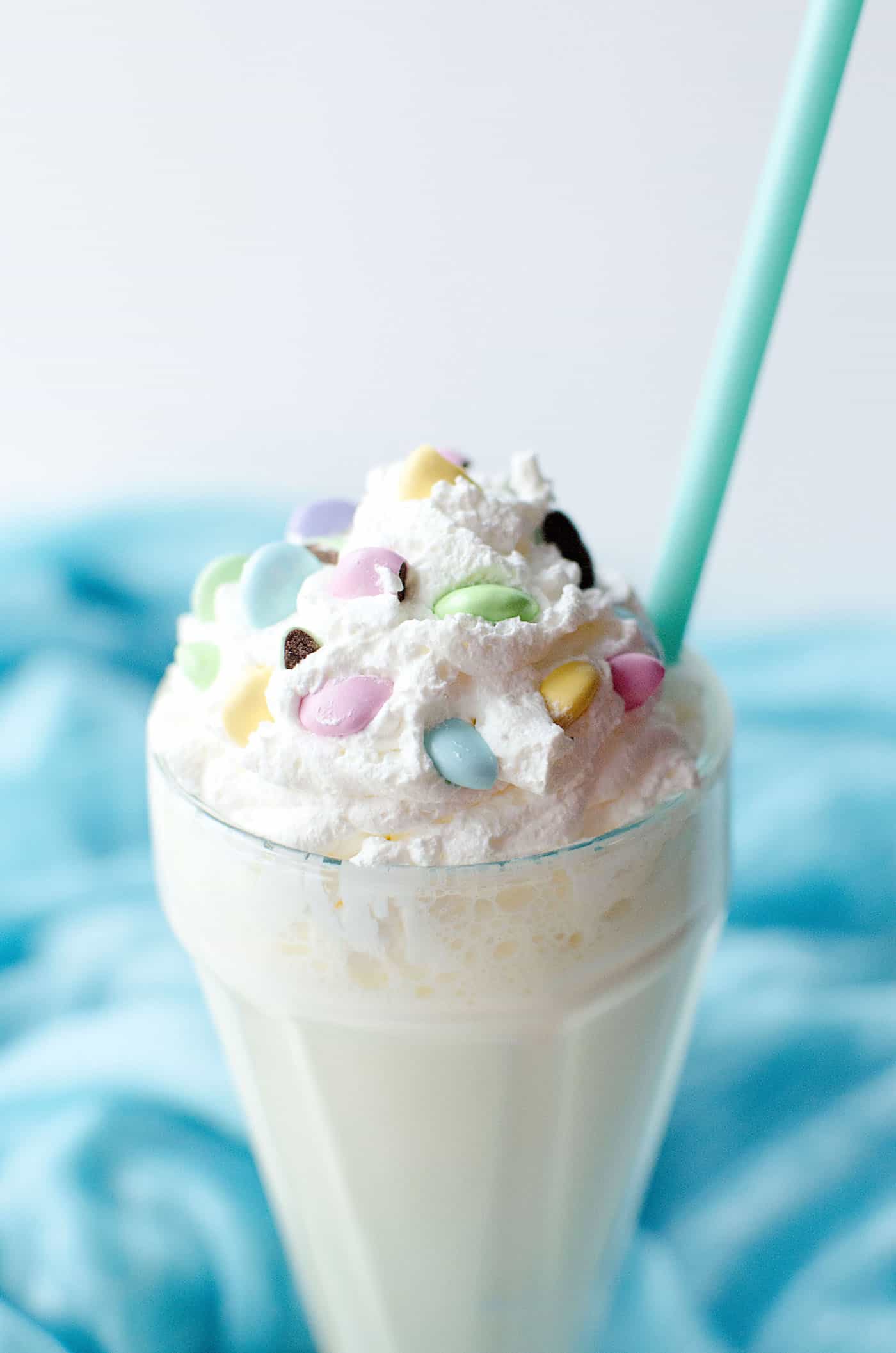 Celebrate the holidays (or any time of year) with this delicious banana milkshake! Whipped cream, Peeps and M&Ms on top make it extra festive. 
