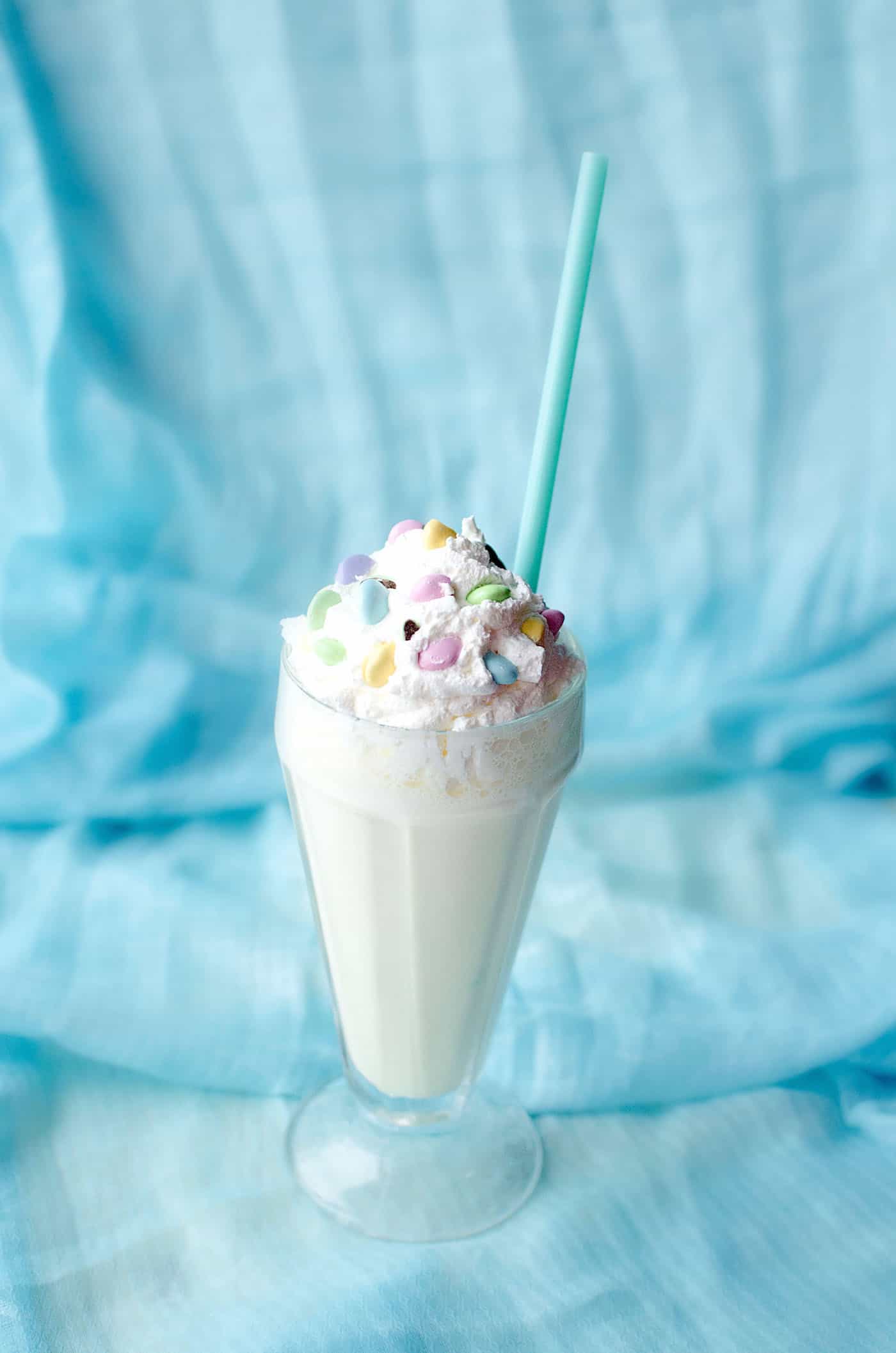 Celebrate the holidays (or any time of year) with this delicious banana milkshake! Whipped cream, Peeps and M&Ms on top make it extra festive. 
