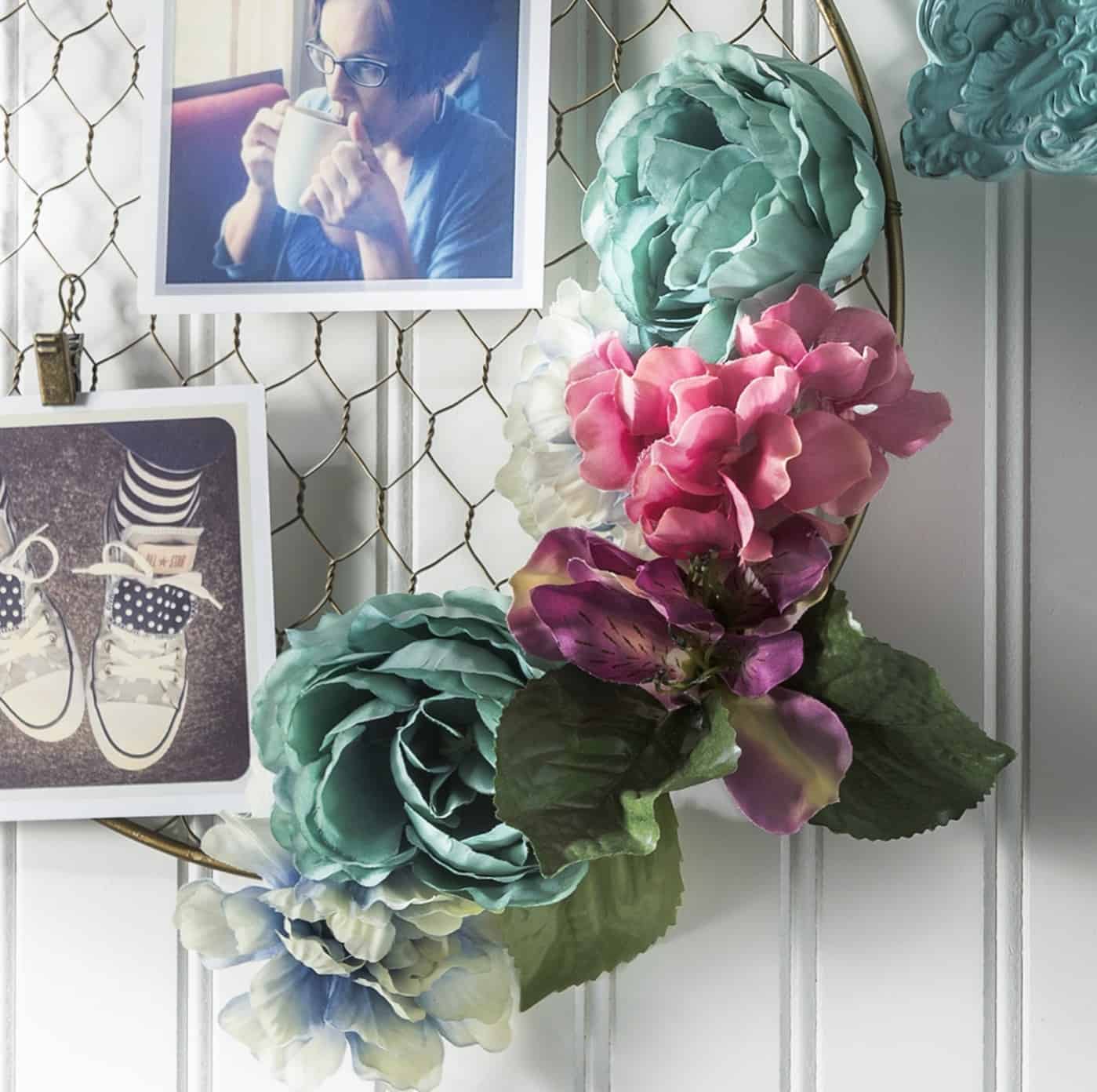 Faux flowers on a metal hanging photo frame