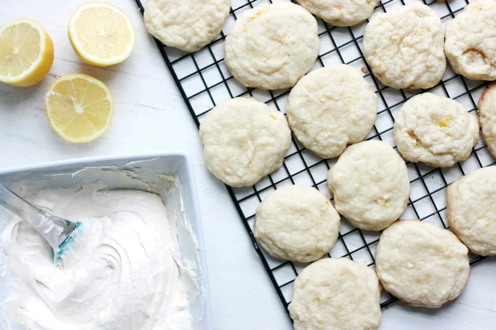 Lemon cookie recipe with cream cheese frosting sitting in a container on the side