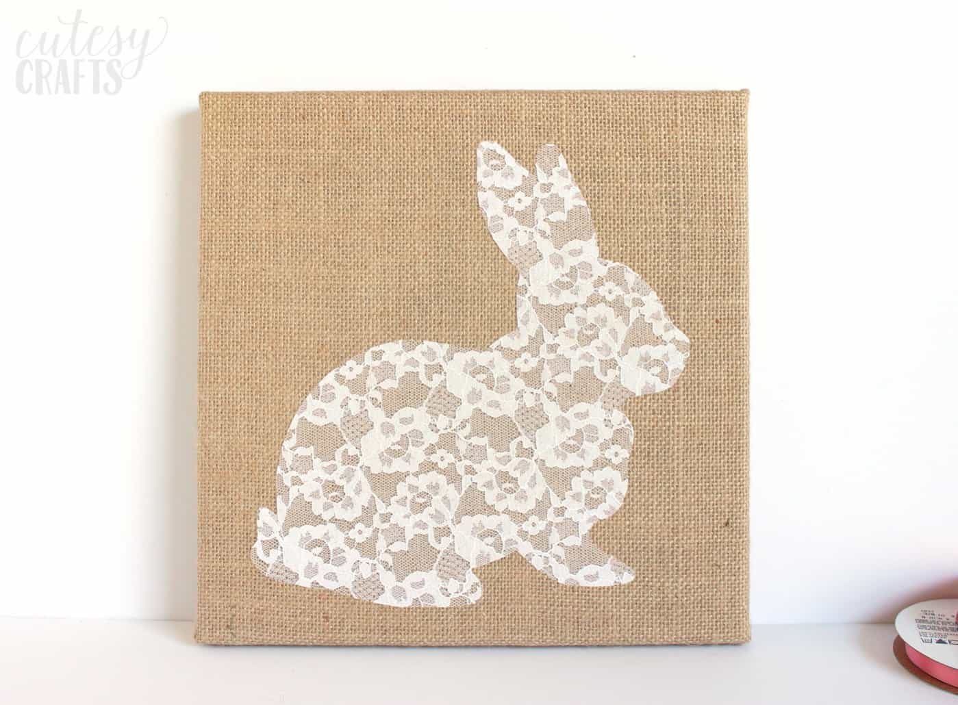 Lace rabbit shape attached to canvas