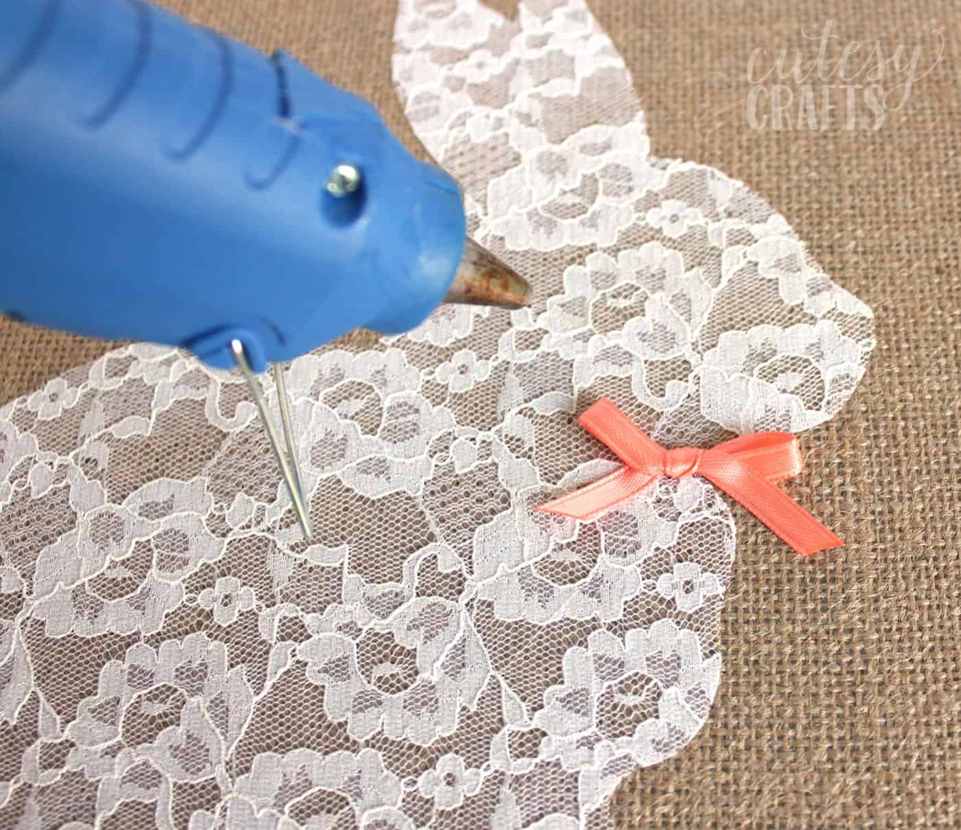 Hot glue gun used to attach the ribbon to the rabbit canvas