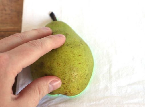 Pear fruit stamped down on a tea towel