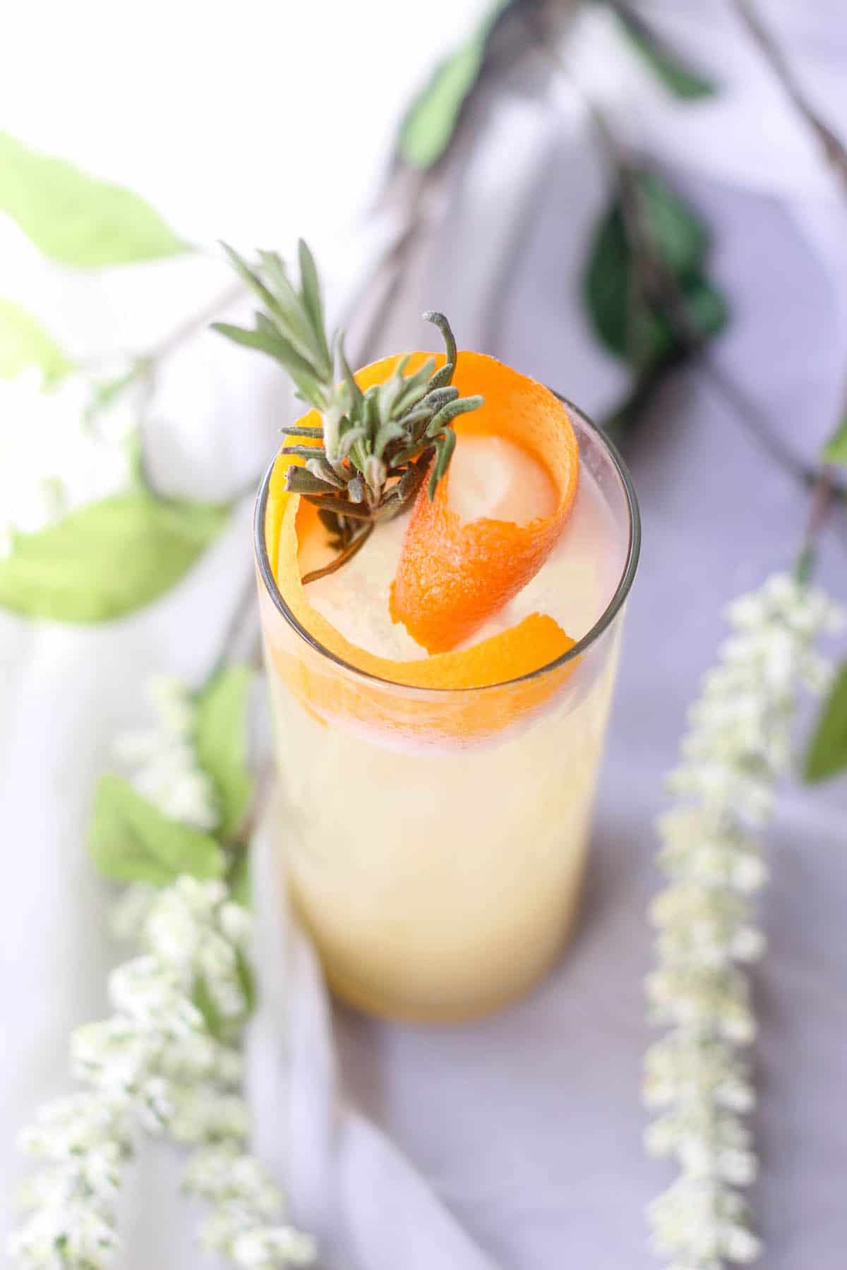 vodka coconut cocktail with orange rind and mint sprigs