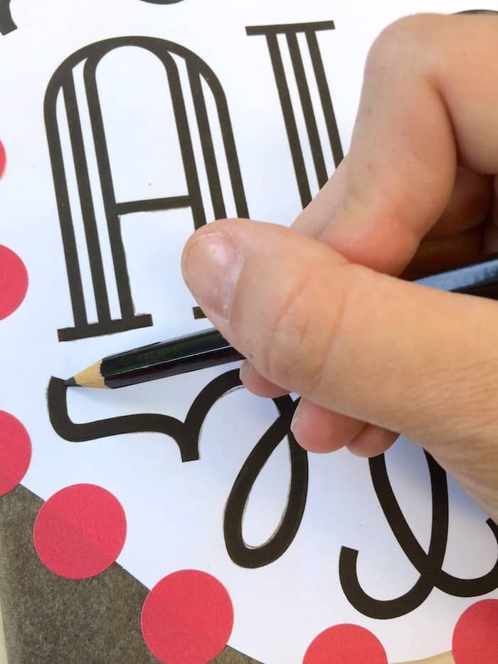 Tracing the wood burning design with a pencil