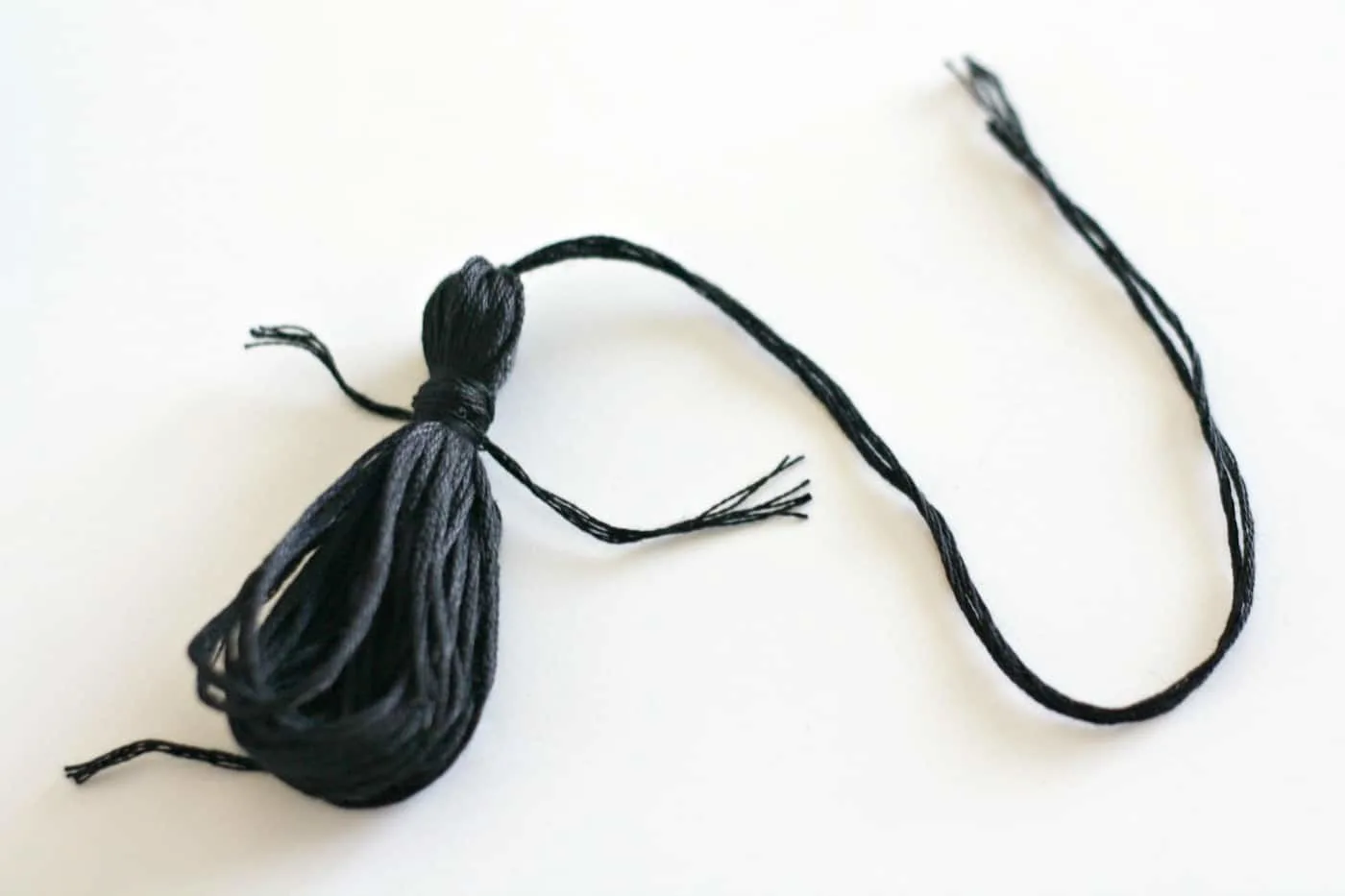 Making a tassel using black embroidery floss