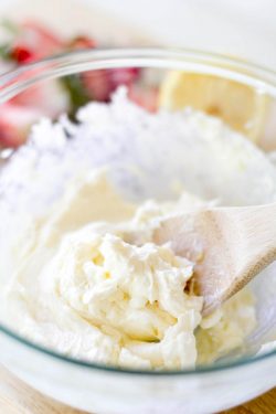 Mixing together cream cheese, sugar, lemon juice, zest, and vanilla in a bowl