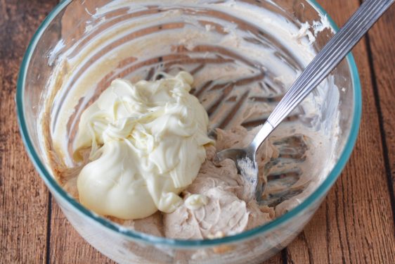 Mixing cream cheese together with melted butter and Oreos