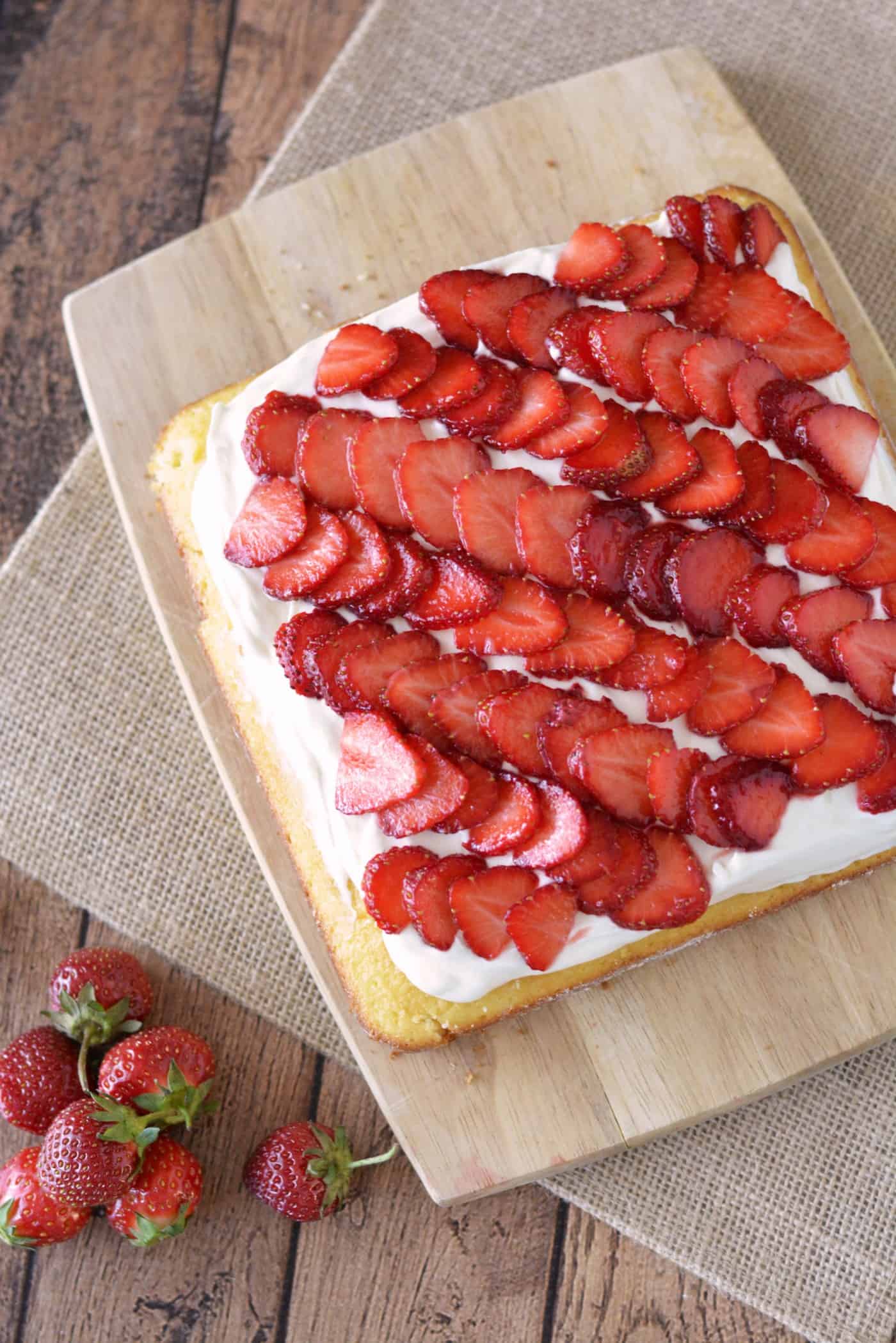 This strawberry cake recipe is a showstopper! It's moist and delicious - and not too sweet. Make this pretty, tasty dessert quickly and easily.