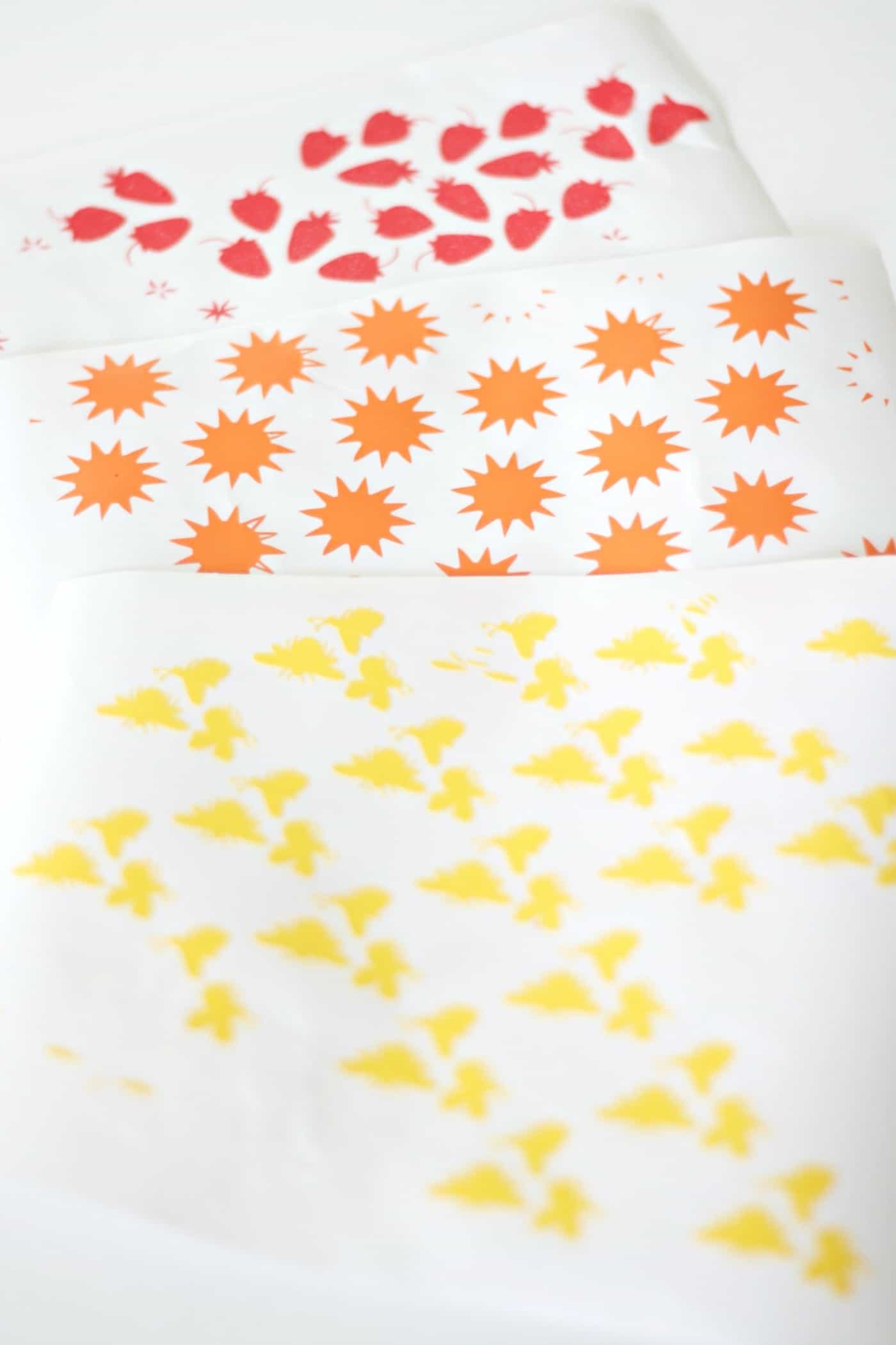 Red strawberry, orange sun, and yellow bee vinyl stickers