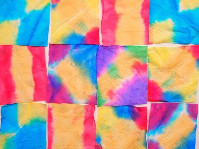 Squares of paper towels dyed with food coloring