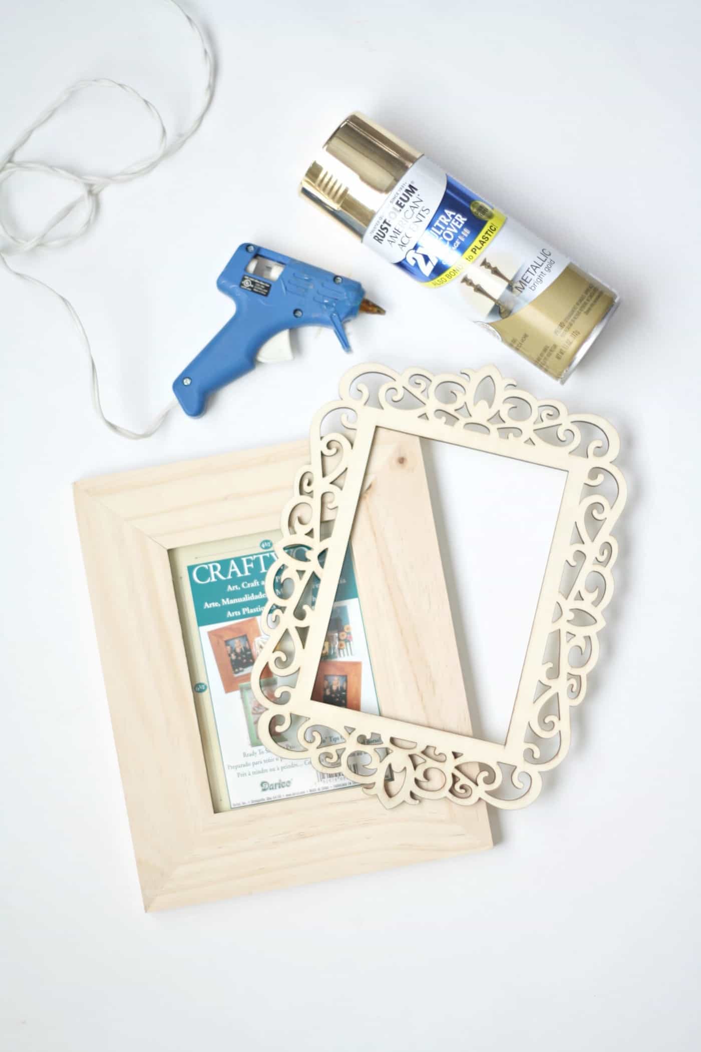 Wood frame, laserjet wood frame overlay, gold spray paint, and a hot glue gun