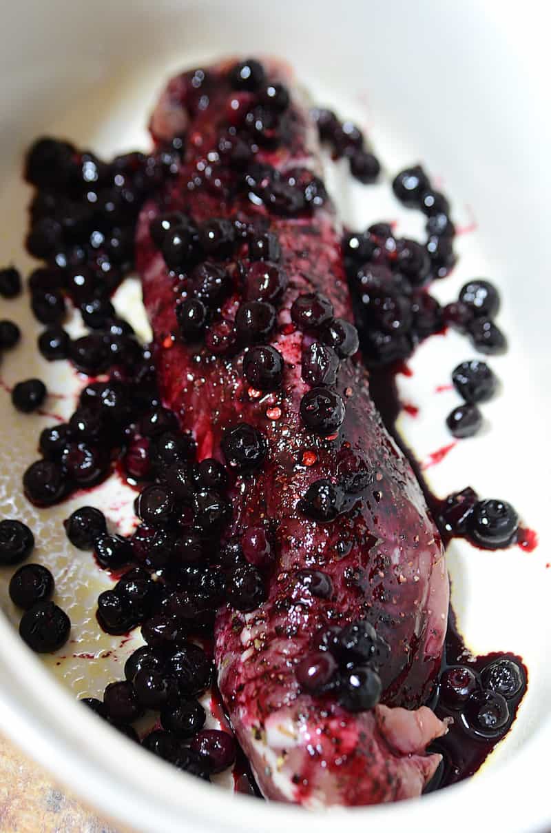 Place blueberry sauce over the top of the raw pork loin
