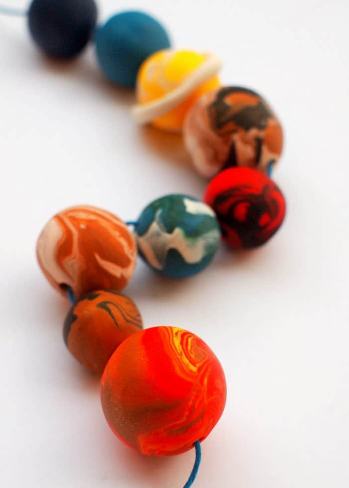 Are you looking for a kids jewelry project that’s out-of-this-world fun? This strand of planets is made with clay - it's really easy to do!