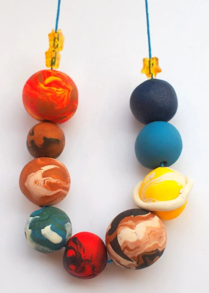 Are you looking for a kids jewelry project that’s out-of-this-world fun? This strand of planets is made with clay - it's really easy to do!