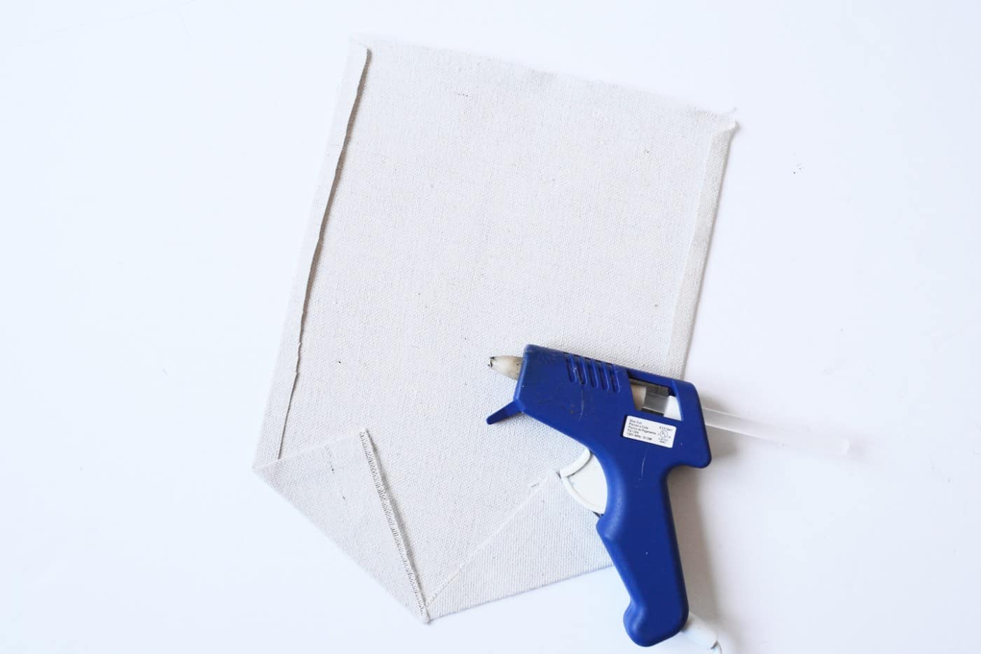 hot glue gun with a piece of canvas