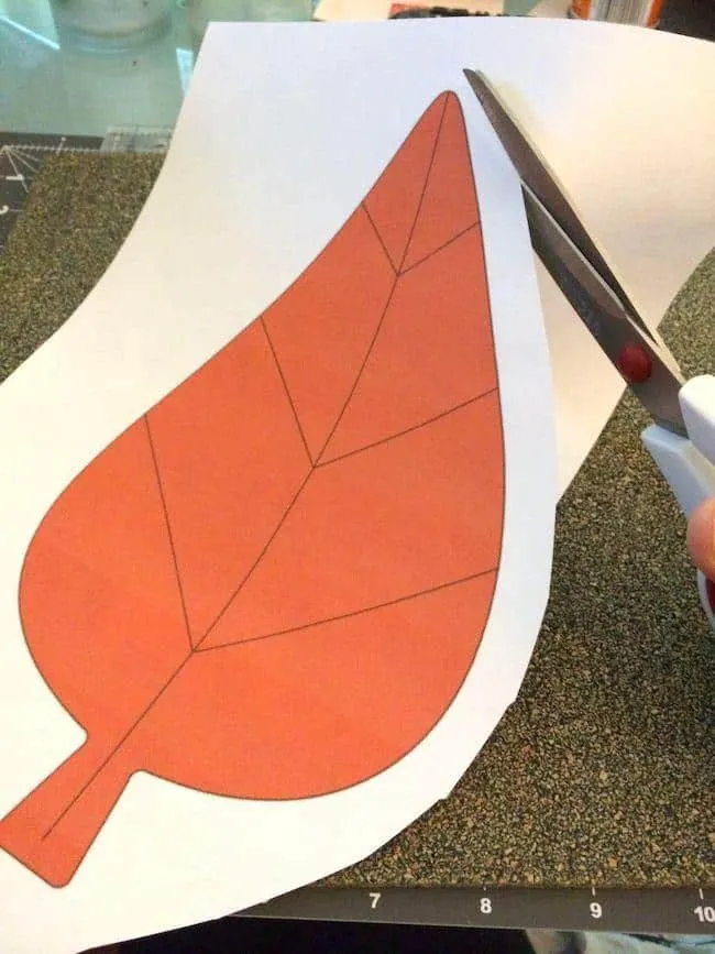 Cutting out an image of a leaf with scissors