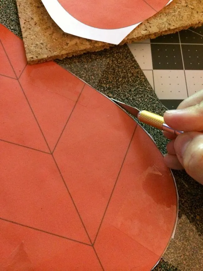 Cutting out a template on cork with a craft knife