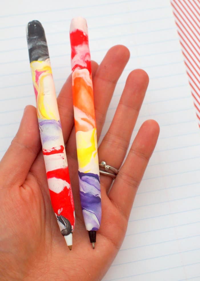 Hand holding polymer clay pens