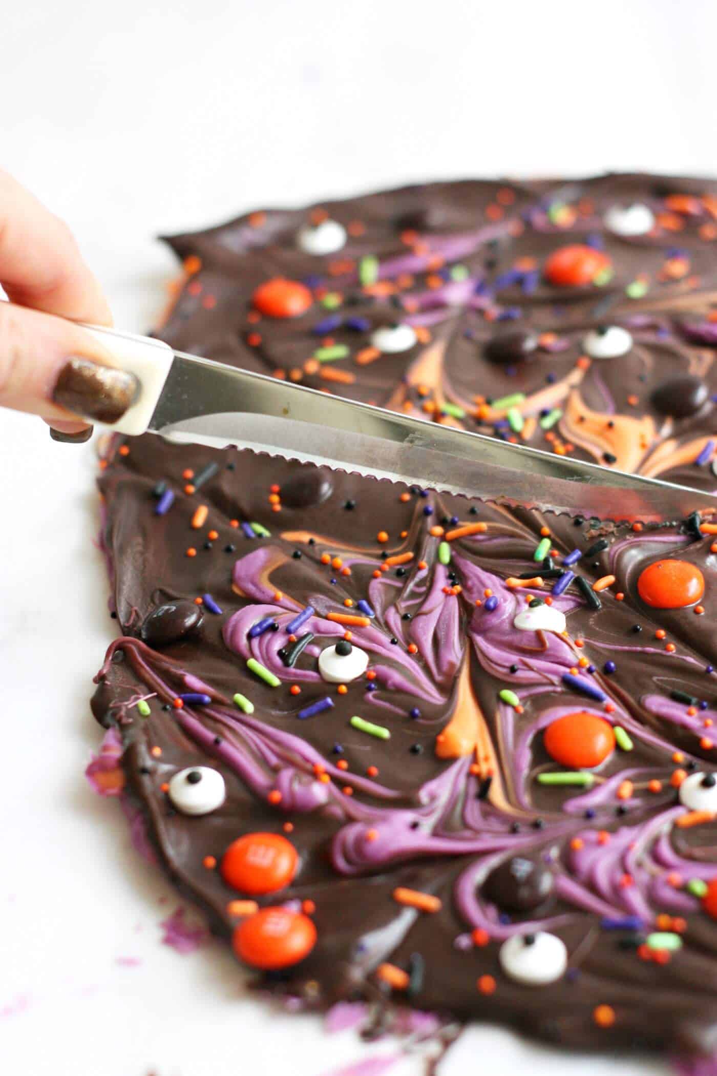 Cutting into the Halloween candy bark