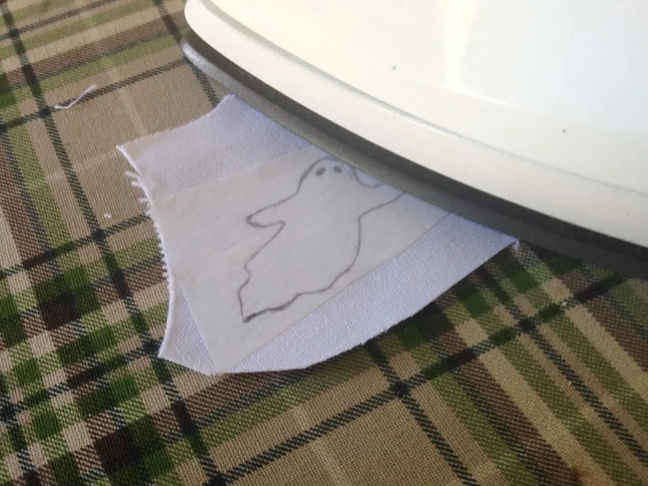 Ironing a ghost pattern onto white fabric